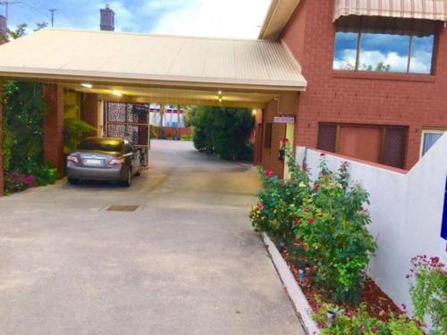 a car parked in front of a house at Albury Central Motel in Albury