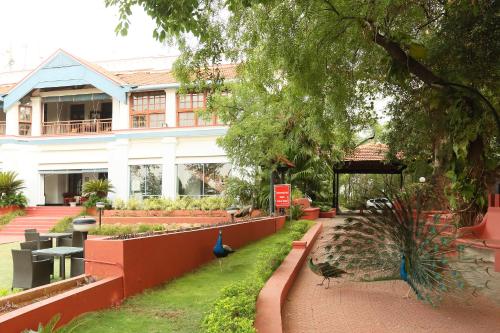 a building with a peacock sitting in front of it at Gateway Madurai in Madurai
