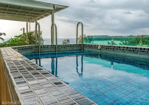 a swimming pool with a view of the water at Hotel Kata Hill Sea View in Kata Beach