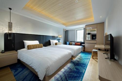 Posteľ alebo postele v izbe v ubytovaní Osaka Excel Hotel Tokyu