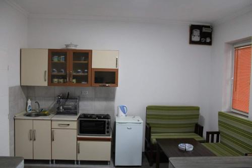 a small kitchen with a stove and a refrigerator at NANE in Kruševo