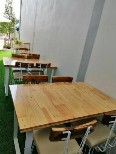 a group of tables and chairs in a room at Promporn Boutique Hotel in Nan