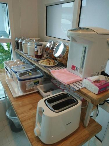 a kitchen counter with a toaster on top of it at Promporn Boutique Hotel in Nan