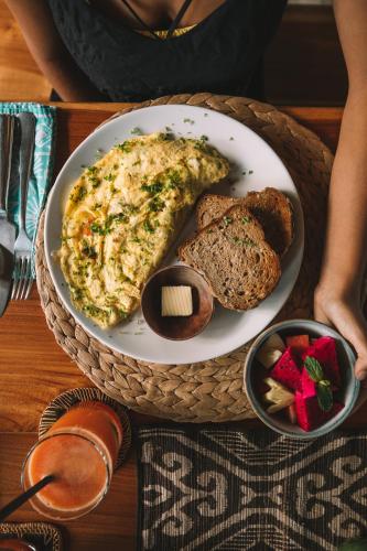 a plate of omelet and bread on a table at Melali Bingin in Uluwatu