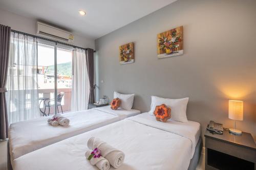 Ένα ή περισσότερα κρεβάτια σε δωμάτιο στο May House Karon Beach