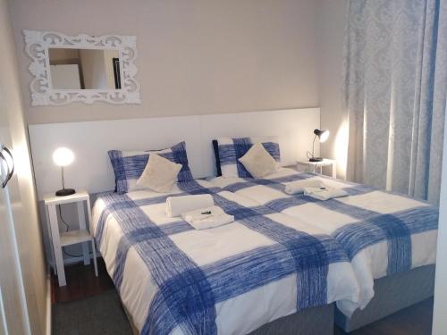 a bedroom with two beds and a mirror on the wall at Village Mews 8 in Sedgefield