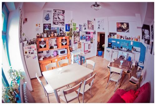 
a living room filled with furniture and a refrigerator at Hostel Bemma - Ozonowane pokoje in Wrocław

