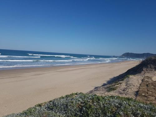 a sandy beach with the ocean in the background at Village Mews 8 in Sedgefield