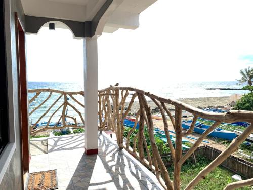 a balcony with a view of the beach at Kobe's Beachfront Haven in Siquijor