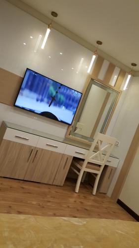 a room with a desk with a tv and a chair at Sheraton Ocean 401 - No Pool Access in Cairo