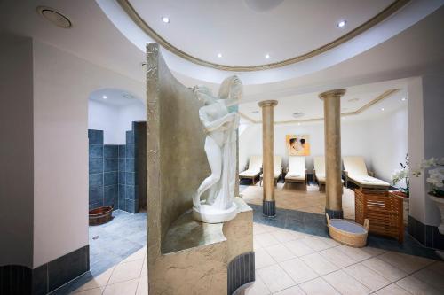 a statue of a woman in a hotel lobby at Posthotel Rotenburg in Rotenburg an der Fulda