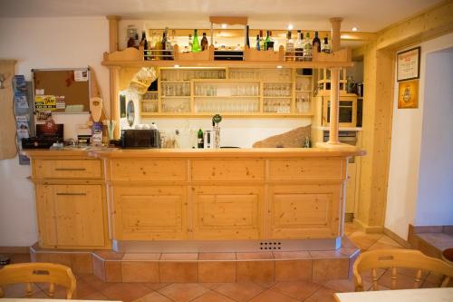 a kitchen with a large wooden island in a room at Tischlmühle Appartements & mehr in Gröbming