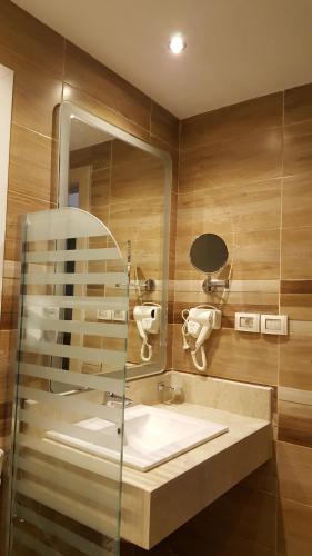 a bathroom with a sink and a mirror at Sheraton Ocean 401 - No Pool Access in Cairo