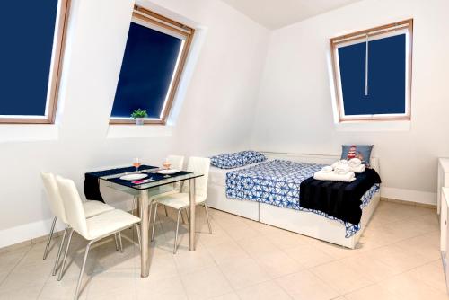 a bedroom with a bed and a table and chairs at Super Center, Modern Studio under the stars in Burgas City