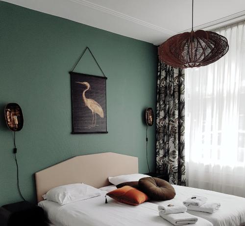 Postel nebo postele na pokoji v ubytování Hotel Kuiperduin