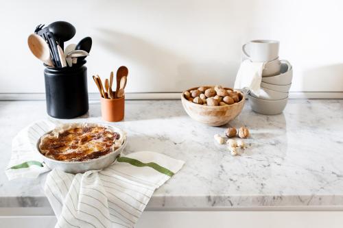 a kitchen counter with bowls of food and utensils at Il Lavatoio in Cissano
