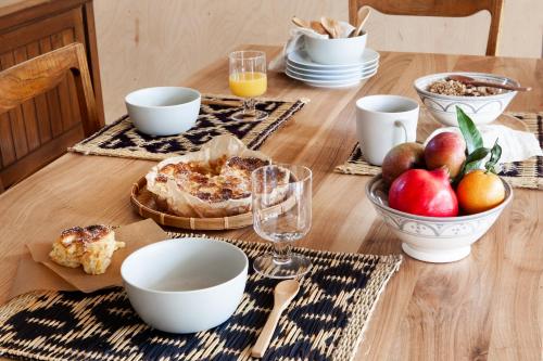 a wooden table topped with plates and bowls of food at Il Lavatoio in Cissano