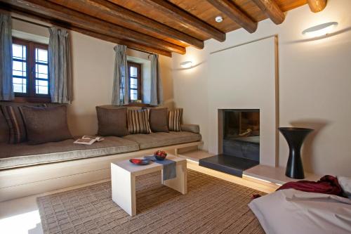 a living room with a couch and a fireplace at Kipi Suites in Kipoi