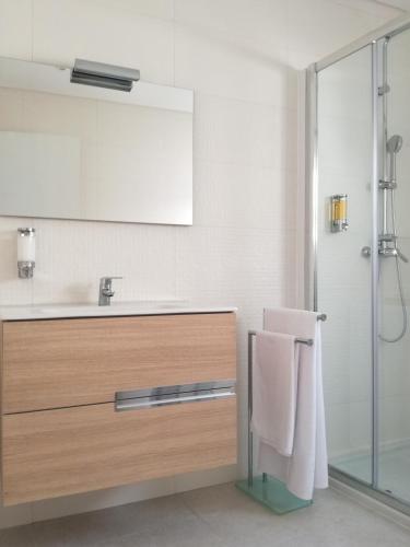 a bathroom with a sink and a mirror at Casa da Levada in Ribeira Grande