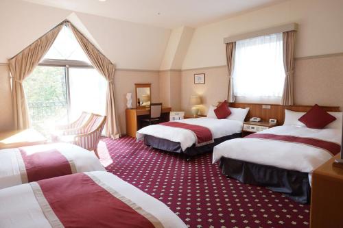 Un pat sau paturi într-o cameră la Hotel Floracion Nasu