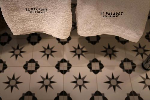 two towels sitting on top of a tiled floor at El Palauet del Priorat in Cornudella