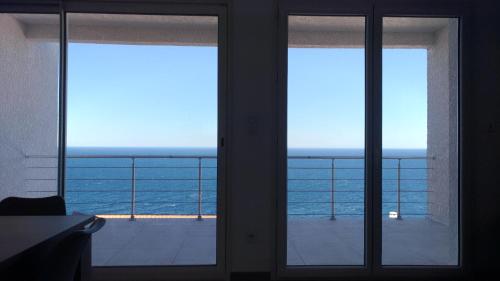 two windows in a room with a view of the ocean at Villa Luxe Vue Panoramique sur la mer piscine clim cassee 4 etoiles meuble tourisme in Cerbère