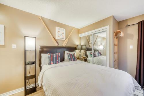 a bedroom with a large white bed and a window at Condo 616 at North Creek Resort in Blue Mountains