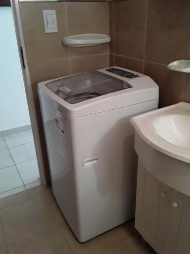 a washing machine in a bathroom next to a sink at El Balcón 2 in Concepción del Uruguay