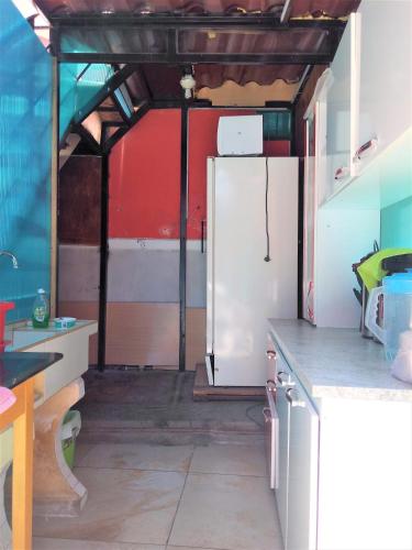 a kitchen with a white refrigerator in a garage at Casona Moya in Arequipa