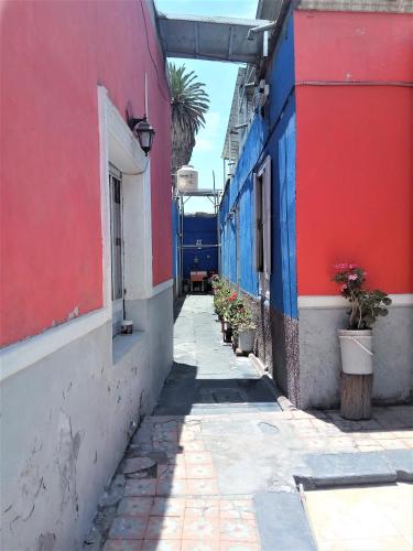 an alley with colorful buildings and potted plants at Casona Moya in Arequipa