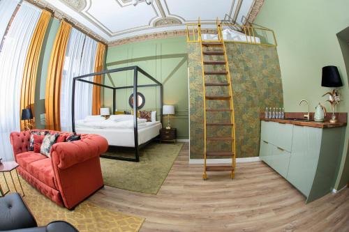 a room with a bed and a ladder and a red couch at Apartamenty Nova 22 in Toruń