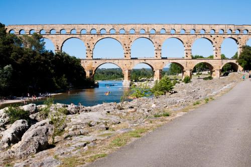 un puente con arcos sobre un río y una carretera en Sinti, en Saint-Hilaire-dʼOzilhan