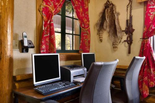 a desk with a laptop computer and a printer at Super 8 by Wyndham Jackson Hole in Jackson
