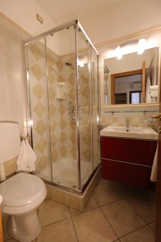 a bathroom with a shower and a toilet and a sink at Il Villino Agriturismo B&B in Belforte del Chienti