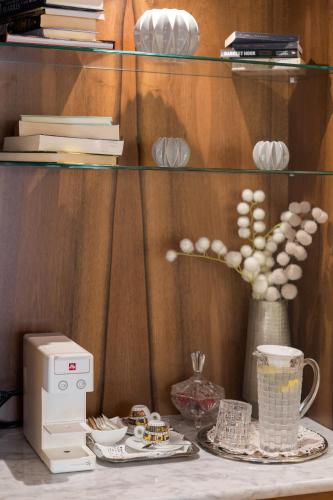 a shelf with a printer and a vase with eggs at Boutique Hotel San Rocco in Brtonigla