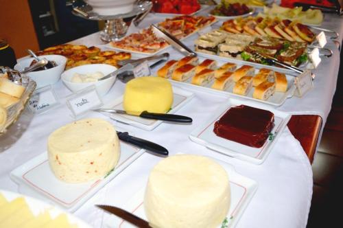 a table topped with lots of different types of food at Vila Verde Hotel in Toledo
