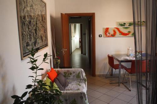 a living room with a table and a chair at Casa Il Gelsomino in Bologna