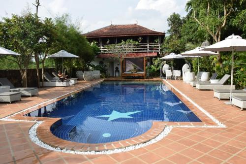 a swimming pool with a star in the middle at TARA LODGE Haven of peace in Kep