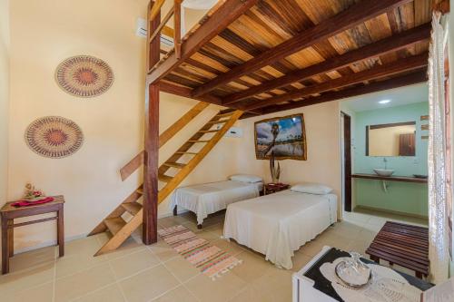 a bedroom with two beds and a staircase at Casa de Caboclo in Canárias