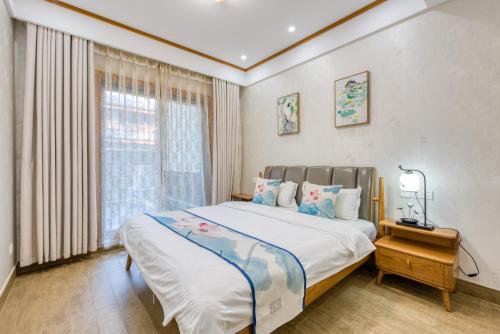 una camera con un grande letto e una finestra di 拈花湾景区内花园庭院别墅套房---购票入住 a Wuxi