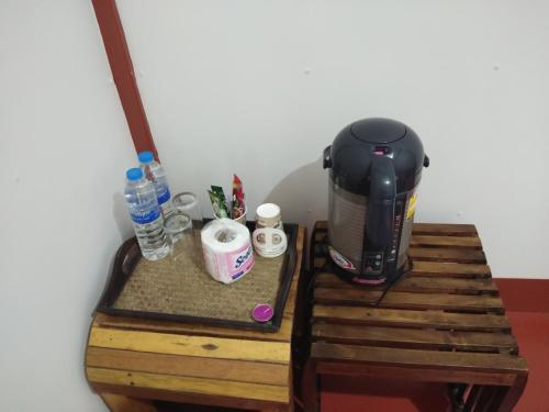 a coffee maker sitting on top of a wooden table at Huan Kaw Fang in Mae On