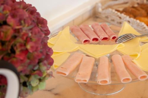 a group of hot dogs on a plate on a table at Casa das Carpas in Vizela