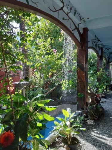 an archway in a garden with plants at Toni Arts Villa in Nabas