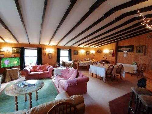 a large living room with couches and a table at Scorrabrae, Orphir, Mainland Orkney, Scotland, United Kingdom in Orphir