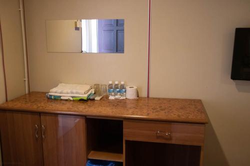 a bathroom counter with a sink and a mirror at Sea Lion Pulau Ketam Inn in Bagan Teochew