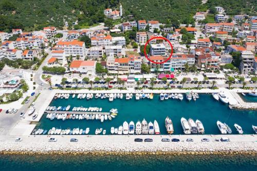 an aerial view of a marina with boats in the water at Emilia Lofts in Tučepi