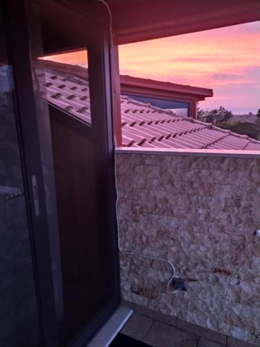 a door to a room with a view of a building at Loft in Palamás
