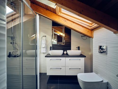 a bathroom with two sinks and a shower at Villa Castelletto heated pool jacuzzi in Kipseli