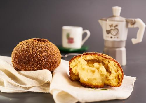 a muffin sitting on a napkin next to a pastry at Rooms Teatro Greco in Catania