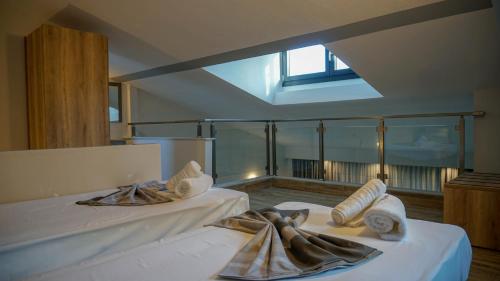 a bedroom with two beds with towels on them at Enalia Luxury Living in Nikiti